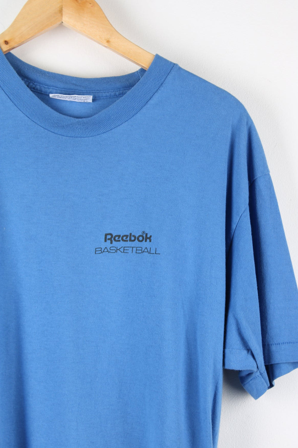 Vintage Reebok Basketball T-Shirt with printed logo on the chest and graphic print on the back.