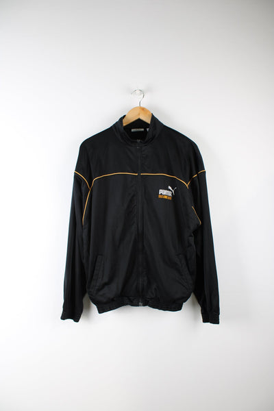 Vintage Puma King tracksuit top featuring embroidered logo on the chest and printed logo on the back.