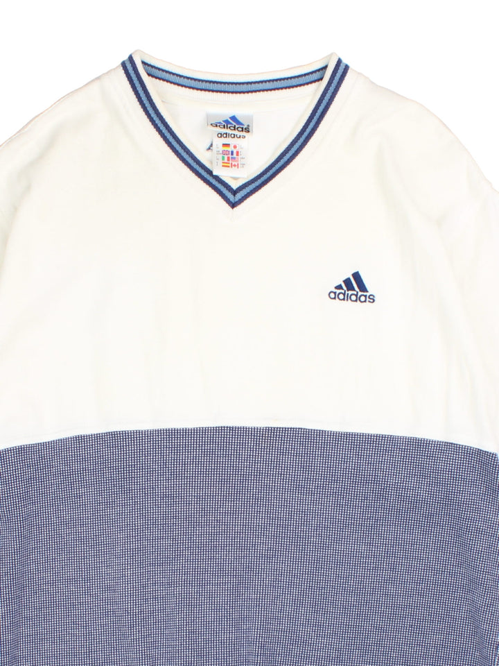 Vintage Adidas v-neck t-shirt in white and blue colors with an embroidered Adidas logo on the front