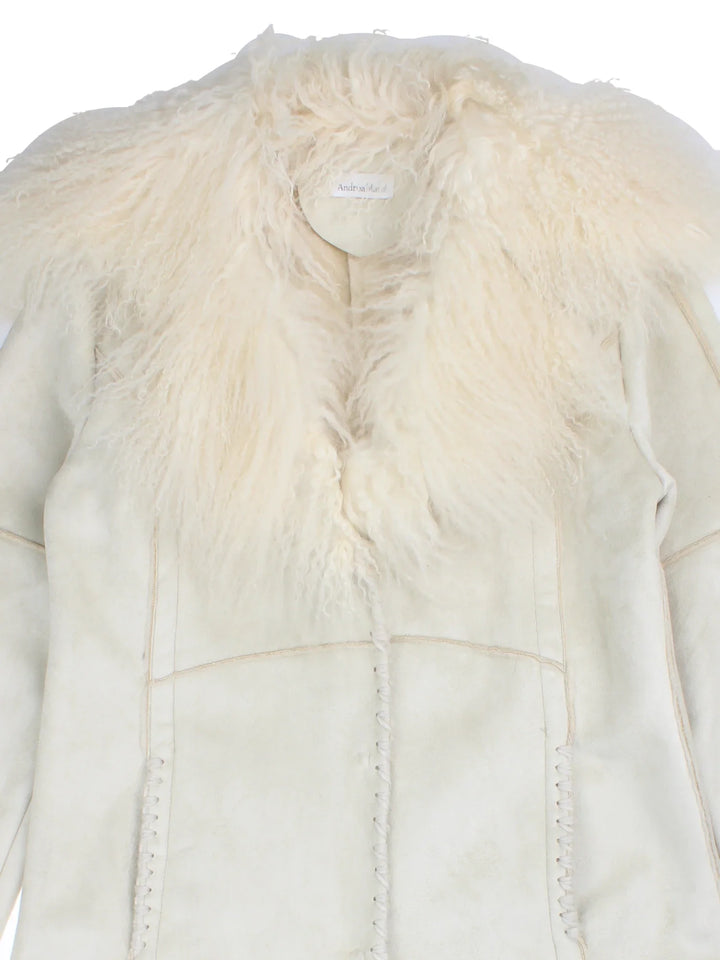 Vintage Mongolian Fur Coat in a white colourway, button popper fastening, top stitch embroidery detail and mongolian fur trim.
