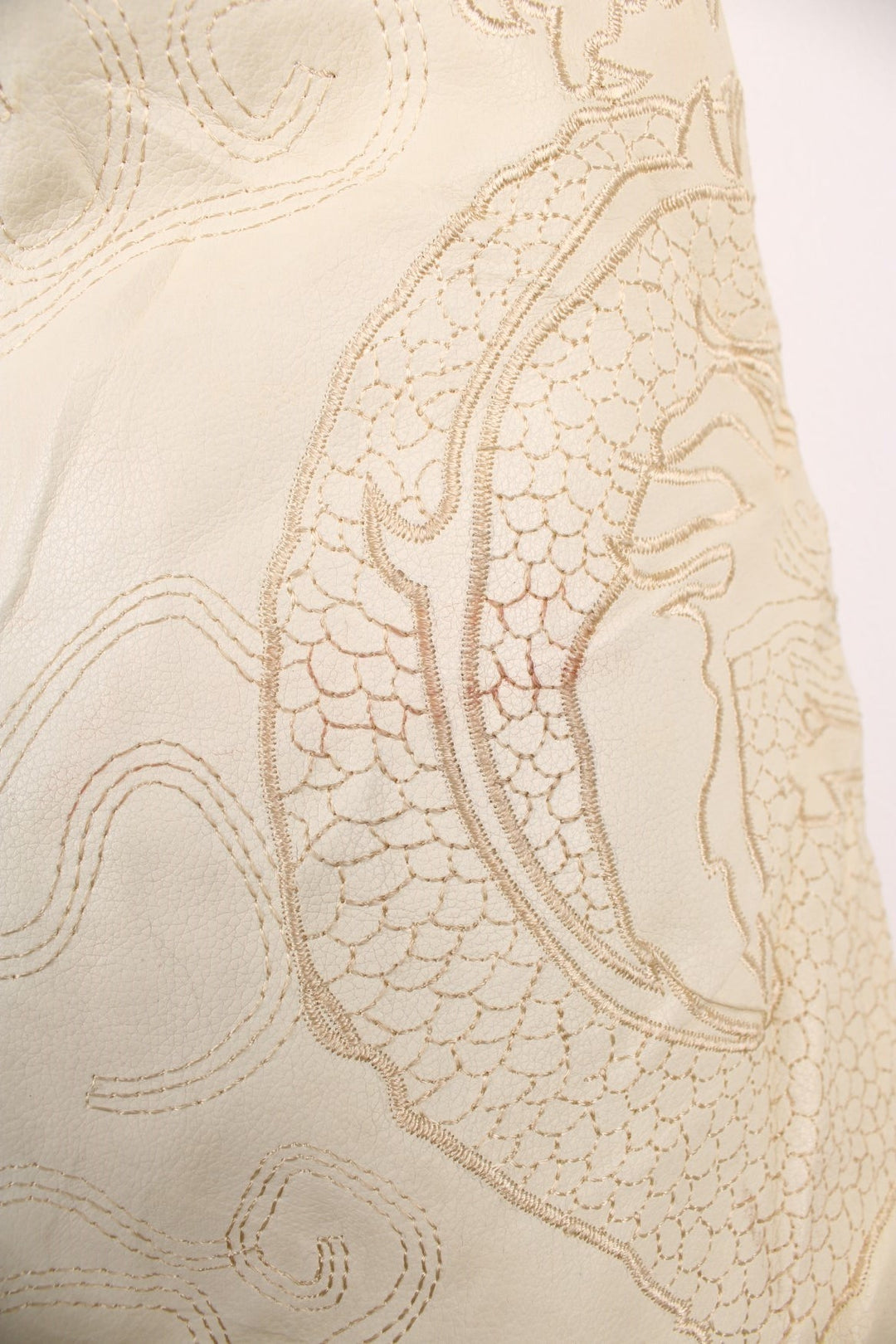 90's Y2K BlueZ Dragon Leather Jacket in a cream colourway, zip up with side pockets, big collar, and has embroidered dragons all over. 