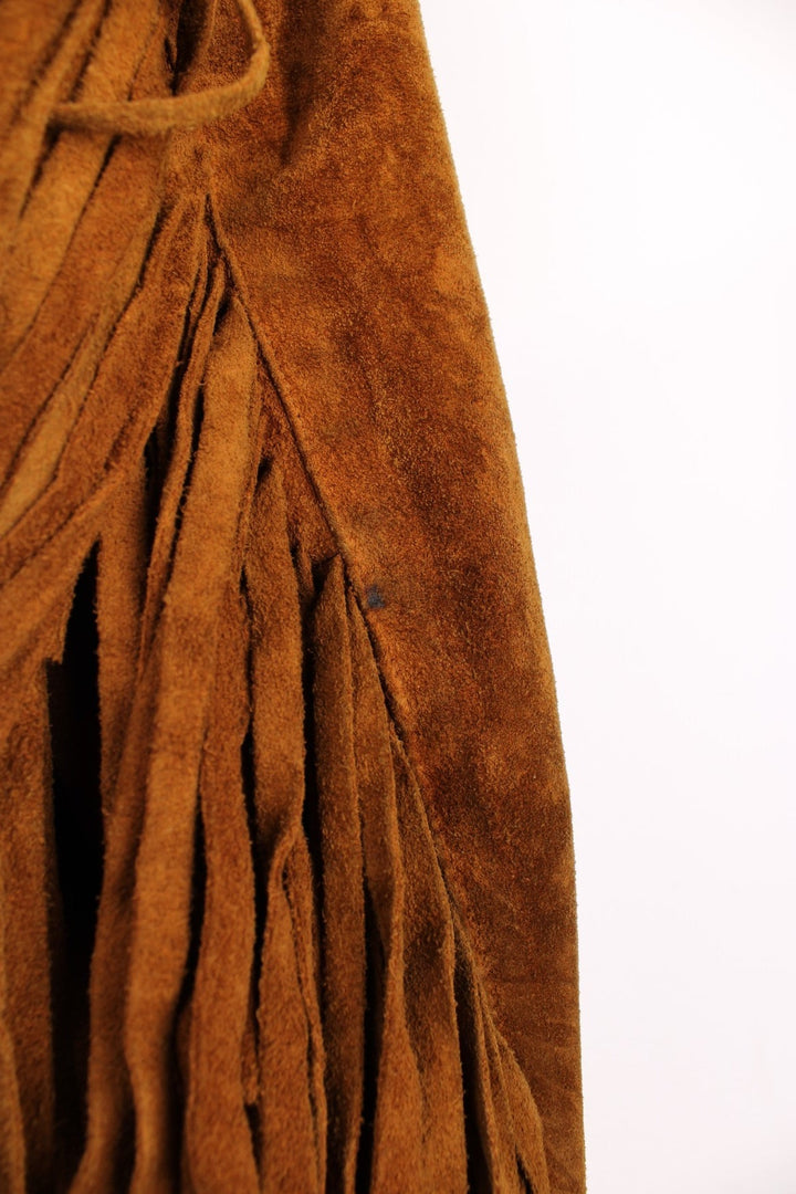 70's Suede Western Fringe Jacket in a brown colourway, button up with double chest pockets, dagger collar, and has tassels all around. 