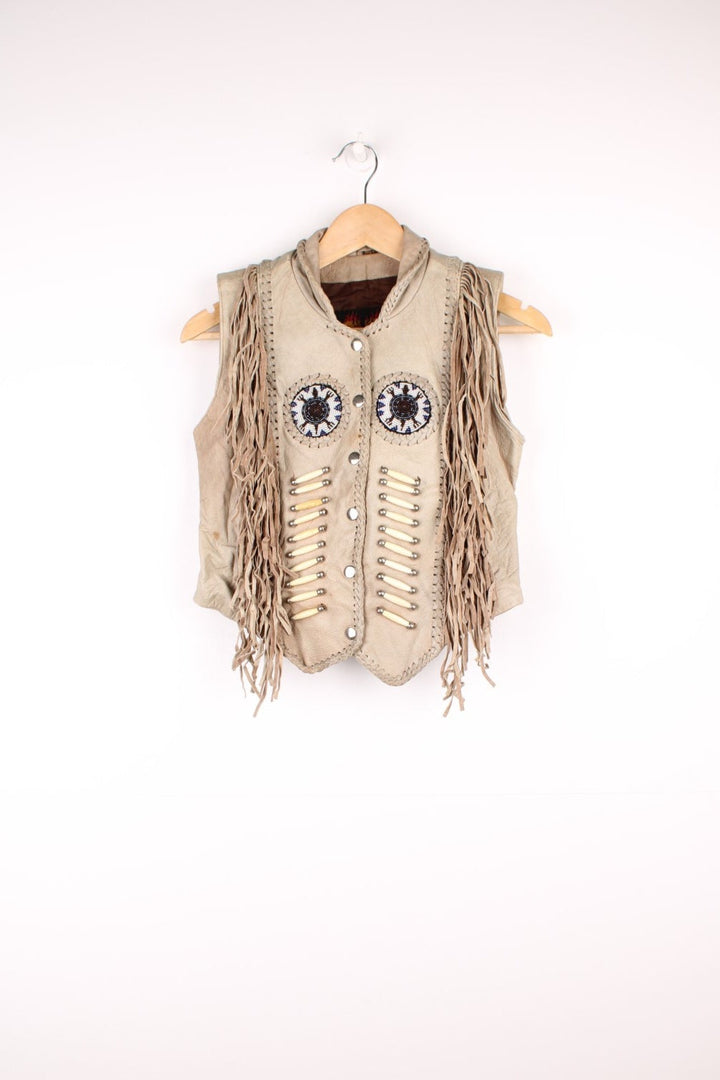 Vintage Native Leather Gilet by 'Hot Leathers' in a tanned colourway, button up, has bones and beades embroiderd on the front alongside the tassels on either side. 