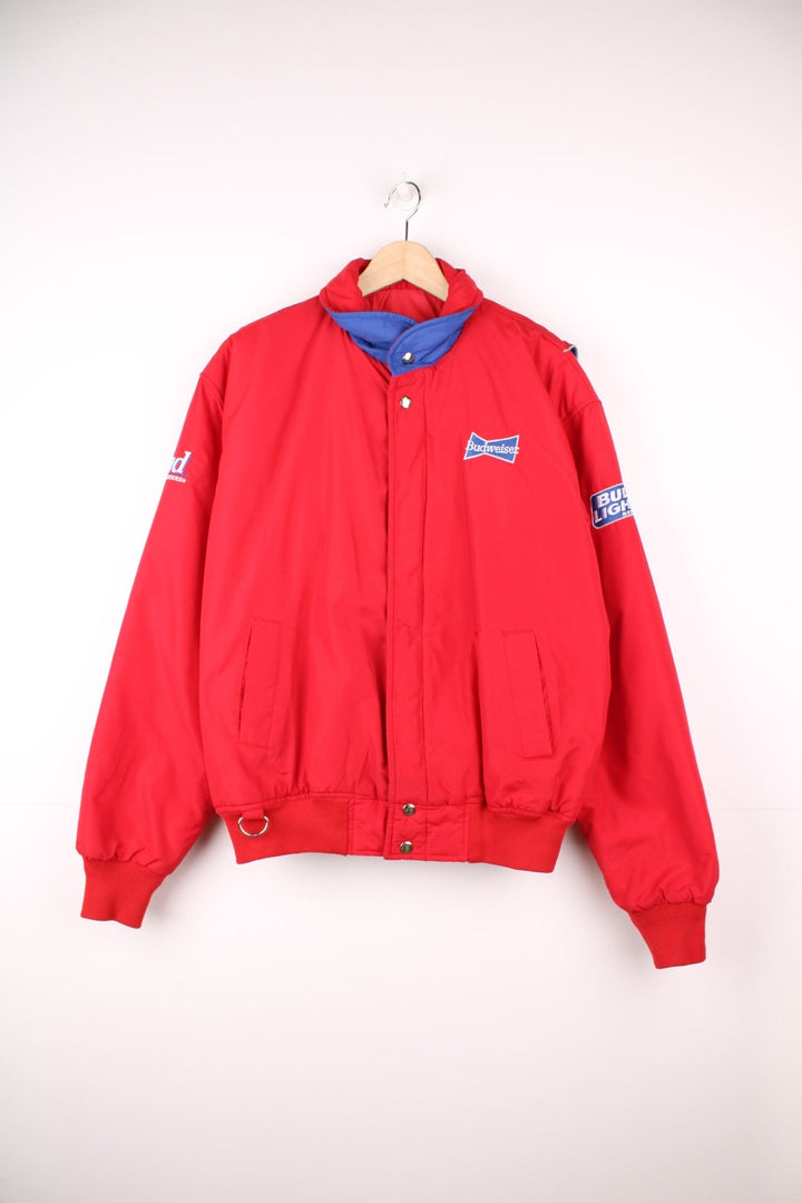 Crown of California bomber jacket in red with snap closure, two pockets and embroidered Budweiser and Bud Light logos on the chest, sleeves and back. 