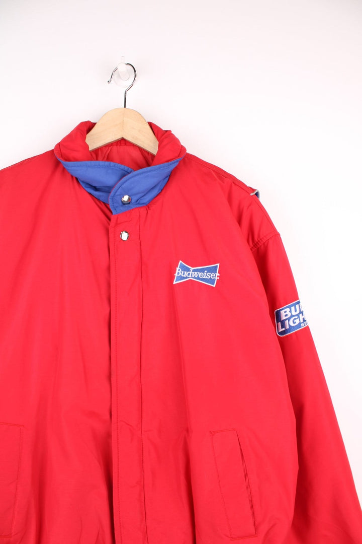 Crown of California bomber jacket in red with snap closure, two pockets and embroidered Budweiser and Bud Light logos on the chest, sleeves and back. 