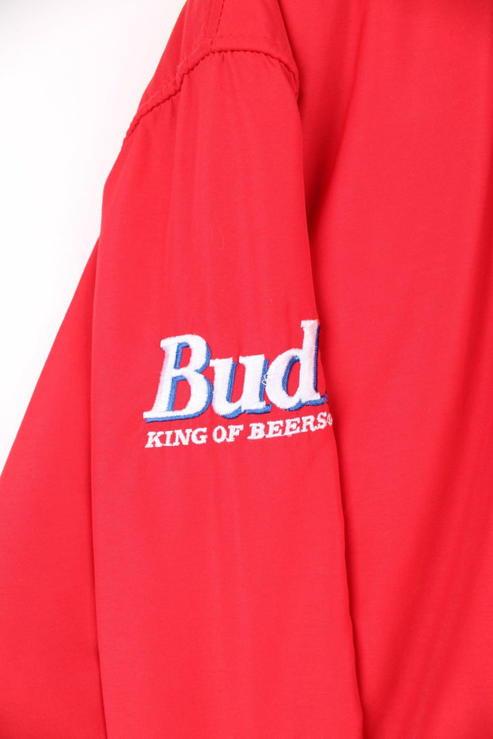 Crown of California bomber jacket in red with snap closure, two pockets and embroidered Budweiser and Bud Light logos on the chest, sleeves and back. 