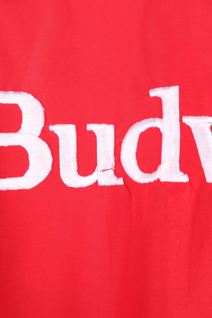 Crown of California bomber jacket in red with snap closure, two pockets and embroidered Budweiser and Bud Light logos on the chest, sleeves and back. 