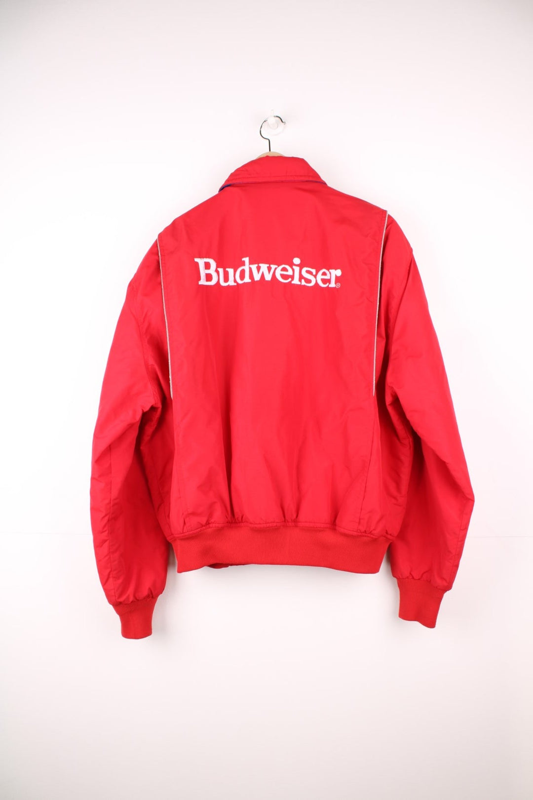 Crown of California bomber jacket in red with snap closure, two pockets and embroidered Budweiser and Bud Light logos on the chest, sleeves and back. 