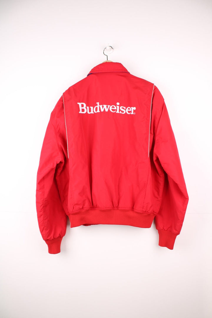 Crown of California bomber jacket in red with snap closure, two pockets and embroidered Budweiser and Bud Light logos on the chest, sleeves and back. 