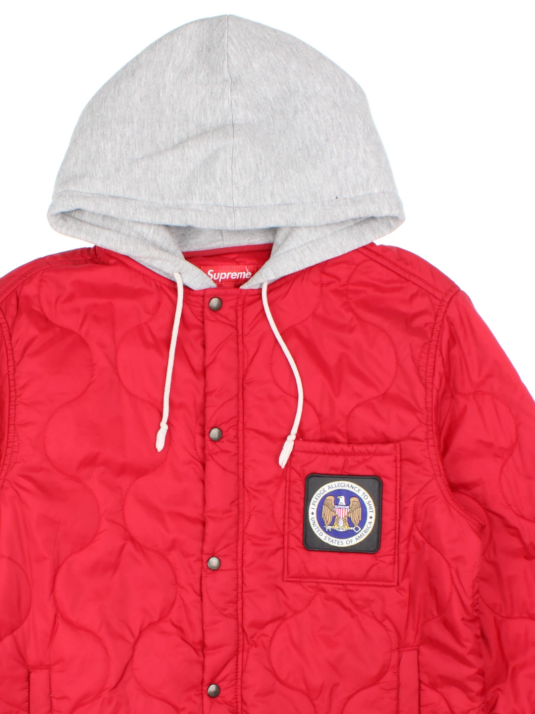 Supreme Quilted Liner Hooded Jacket in a red colourway with a grey cotton hood, "I pledge allegiance to shit, USA" badge embroidered on the front, and has multiple pockets.