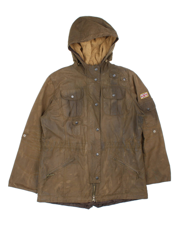 Barbour Winter Force Parka Jacket in a green colourway, zips up and buttons up, has multiple pockets, hooded, insulated with a sherpa lining, and has the logo embroidered on the front.