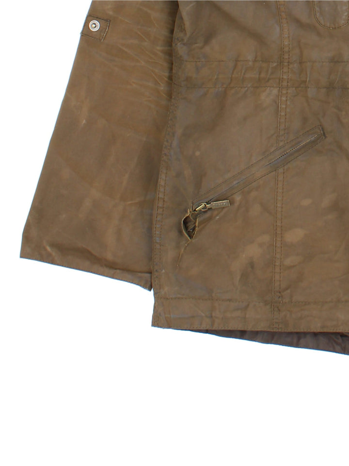 Barbour Winter Force Parka Jacket in a green colourway, zips up and buttons up, has multiple pockets, hooded, insulated with a sherpa lining, and has the logo embroidered on the front.