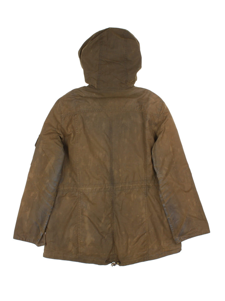 Barbour Winter Force Parka Jacket in a green colourway, zips up and buttons up, has multiple pockets, hooded, insulated with a sherpa lining, and has the logo embroidered on the front.