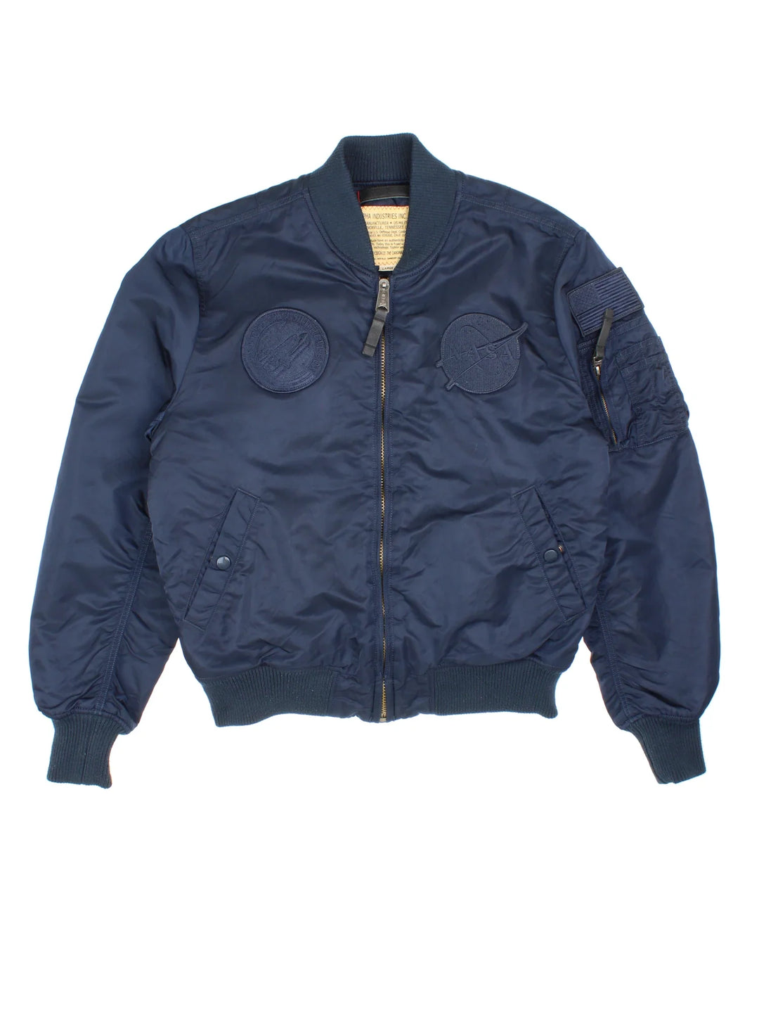Alpha Industries NASA Bomber Jacket in a blue colourway. Zips up and has multiple pockets, insulated lining, and has the logo embroidered on the front and left sleeve.