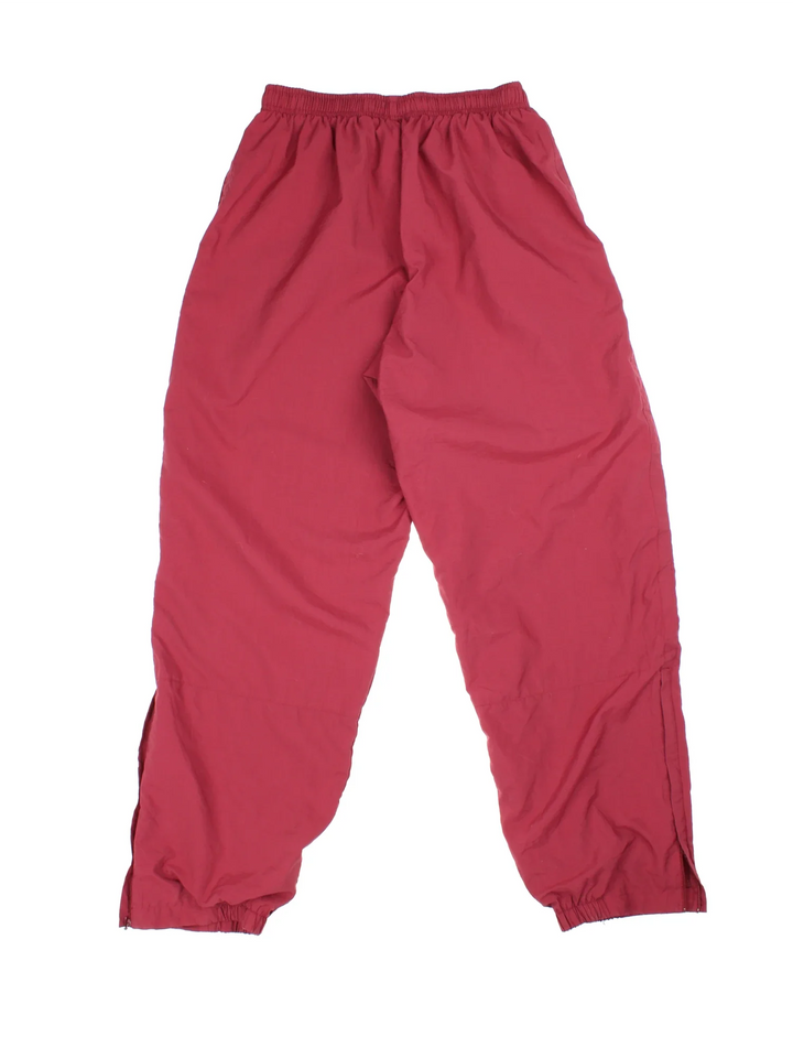 Nike Tracksuit Bottomss in red colourway with two standard side pockets and zip up leg classic Nike Swoosh on the front.
