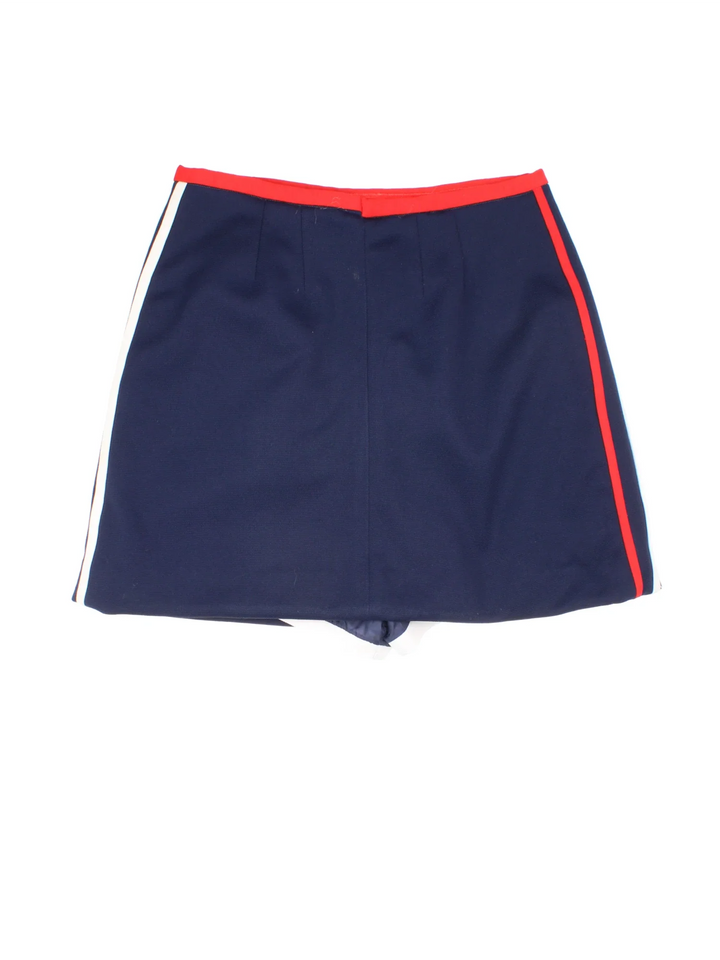 70's Lacoste Mini Skort in blue/red colourway. Button up with built in shorts and embroidered branding on the front.
