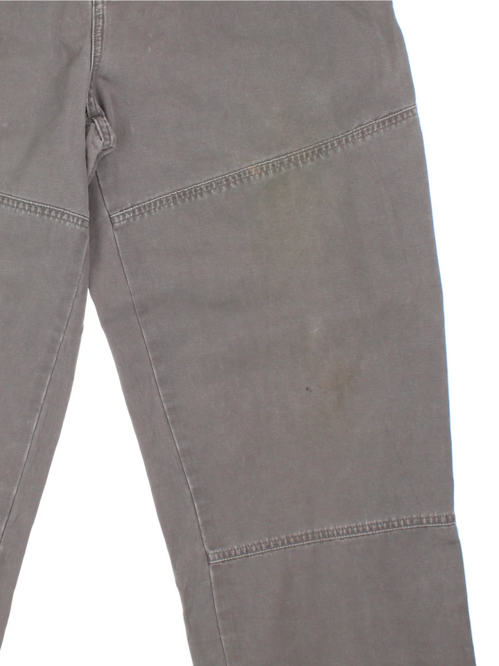 The North Face Double Knee Work Trousers in grey colourway with multiple pockets and the logo embroidered on the front.