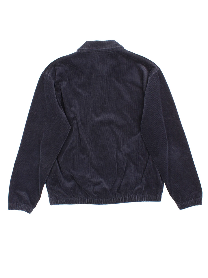 Carhartt Corduroy Jacket in a blue colourway. Zips up and has side pockets, and the logo embroidered on the front.