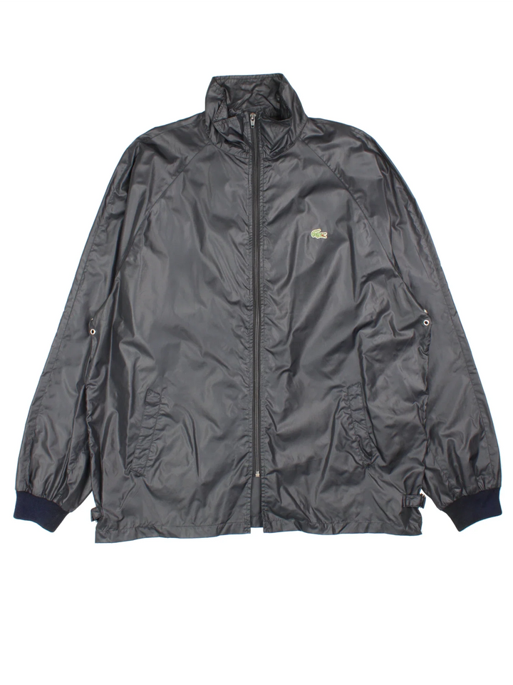 Vintage Lacoste Club Windbreaker Jacket in a black colourway. Zips up and has side pockets, and the logo embroidered on the front.