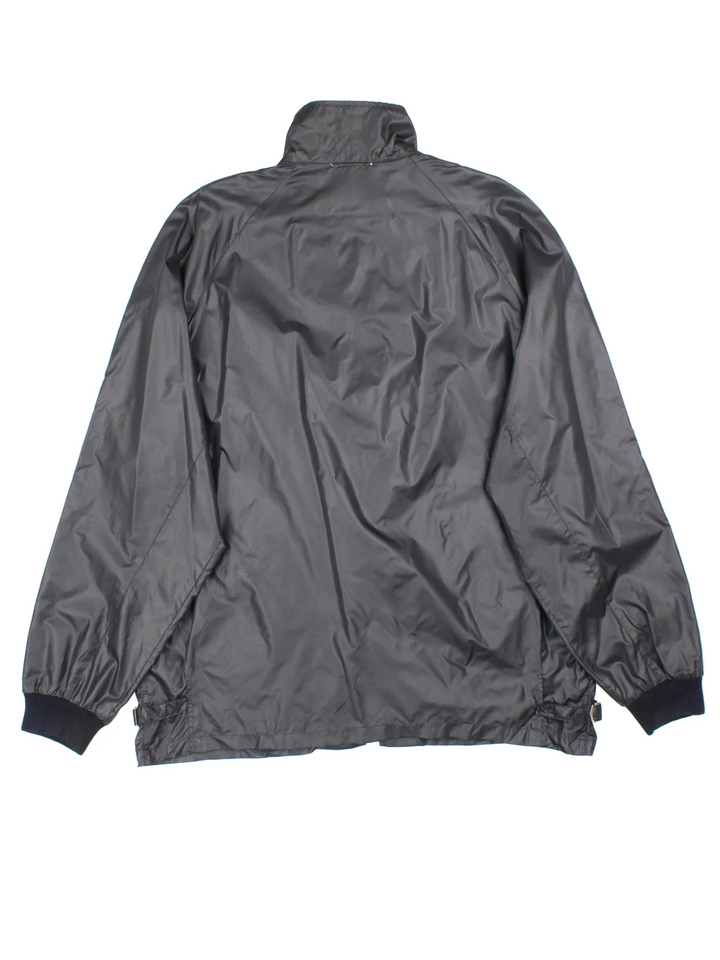 Vintage Lacoste Club Windbreaker Jacket in a black colourway. Zips up and has side pockets, and the logo embroidered on the front.