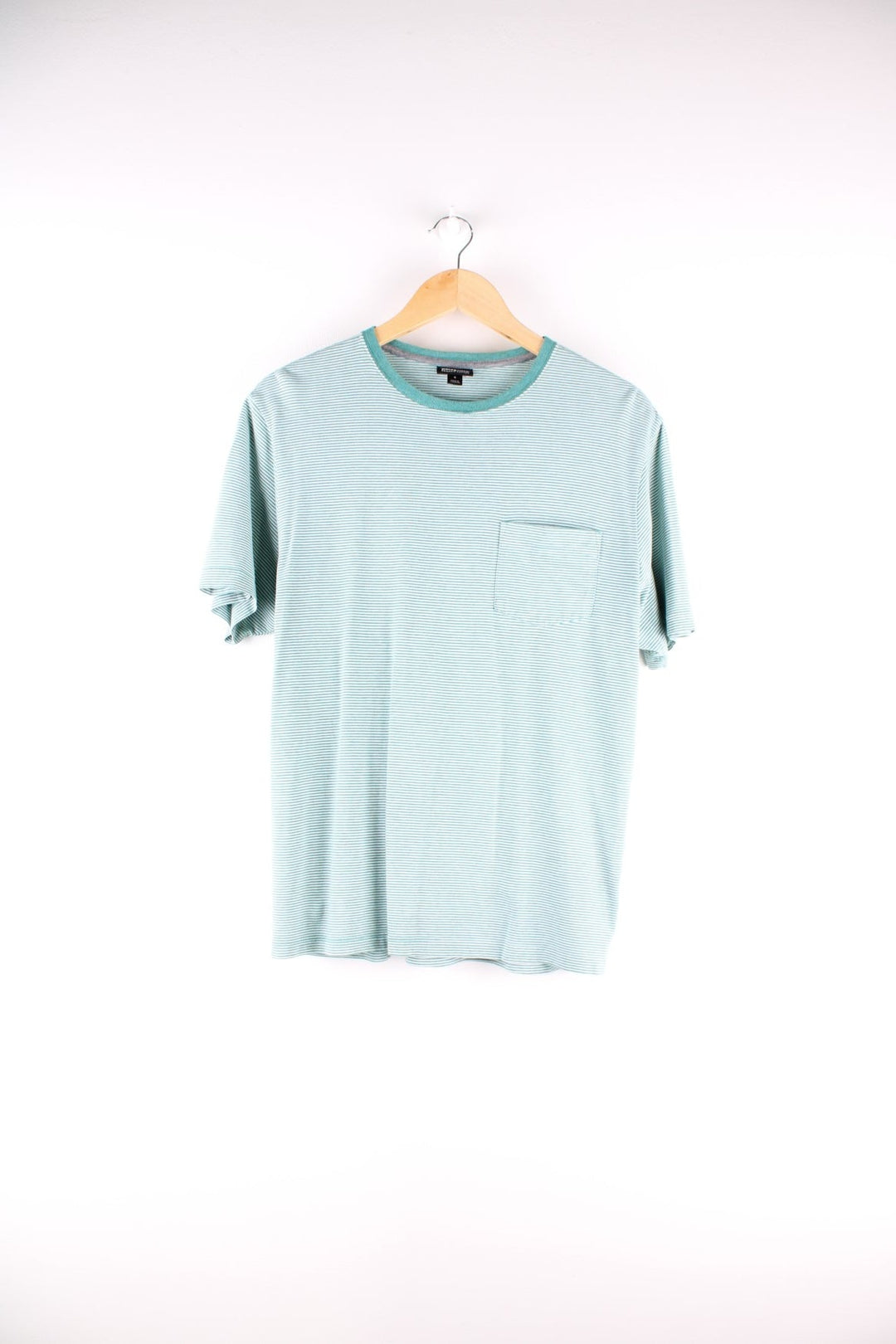 Patagonia organic cotton stiped t-shirt in green and white with one breast pocket and a small logo tab on the lower left side.