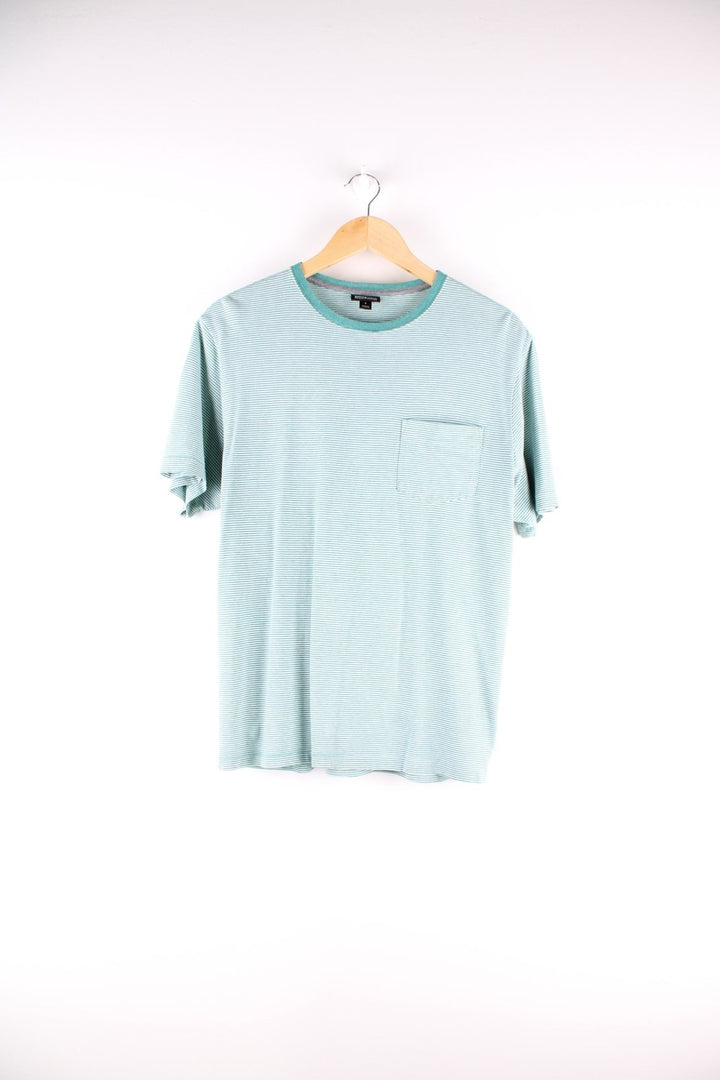 Patagonia organic cotton stiped t-shirt in green and white with one breast pocket and a small logo tab on the lower left side.