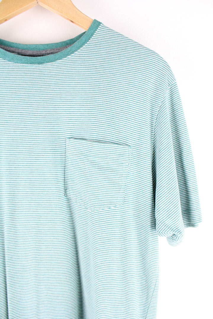 Patagonia organic cotton stiped t-shirt in green and white with one breast pocket and a small logo tab on the lower left side.