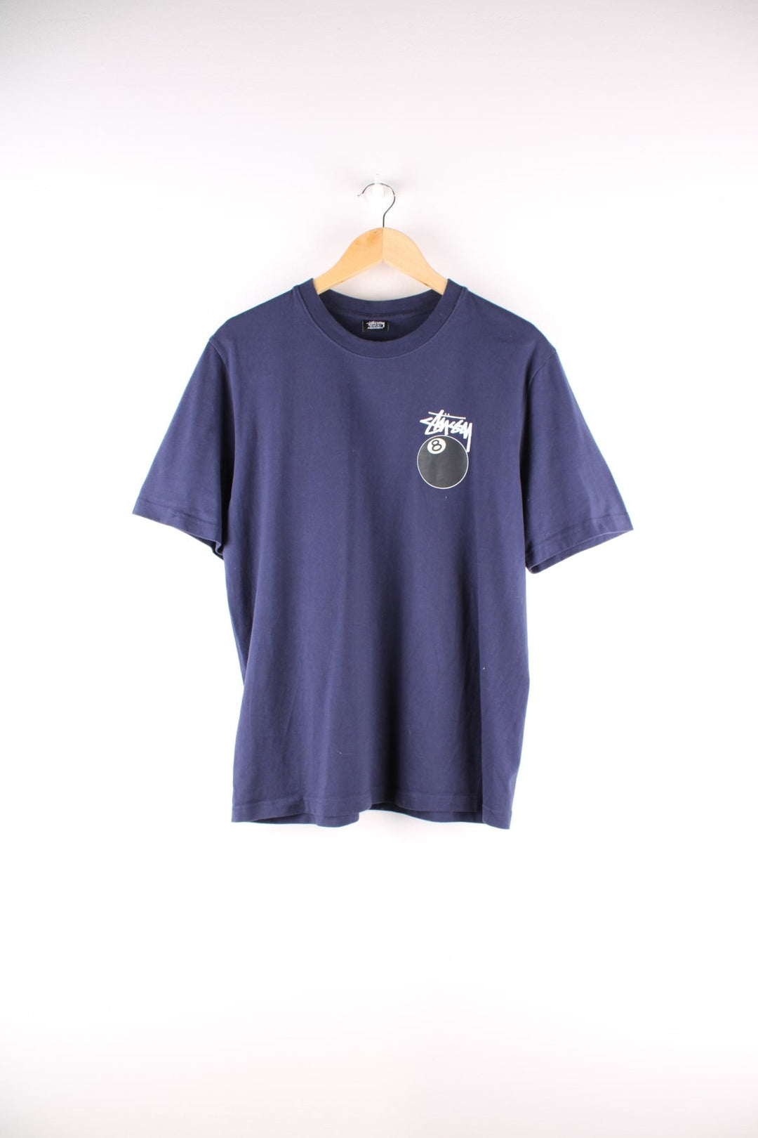 Stussy 8 Ball t-shirt in navy blue with printed logo and 8 ball graphic on the front and back.