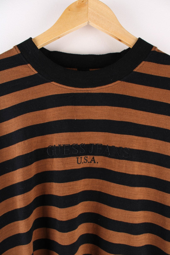 Vintage 90's Guess t-shirt in a brown and black striped colourway with the spell out logo embroidered on the front.