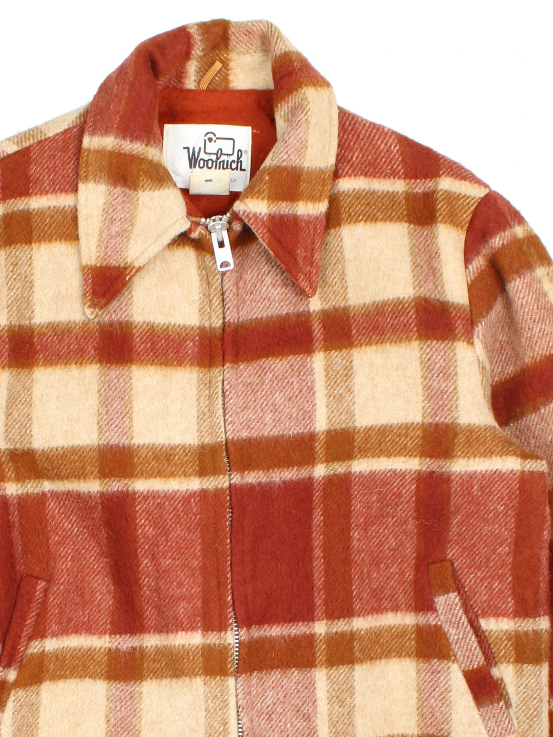 Vintage Woolrich Woollen Plaid CPO Coat in a orange and beige colourway. Zips up and has side pockets, fleece lining, and all over plaid pattern.