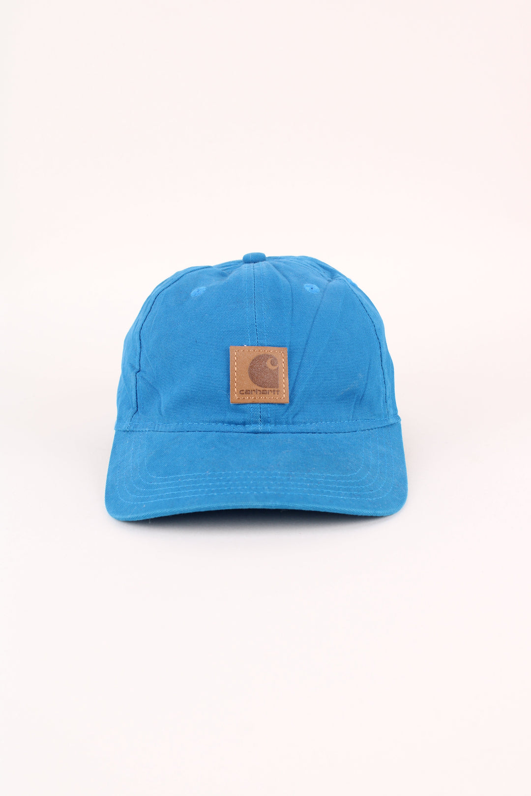Carhartt Cap in a blue colourway with the logo embroidered on the front, and has adjustable velcro strap at the back.