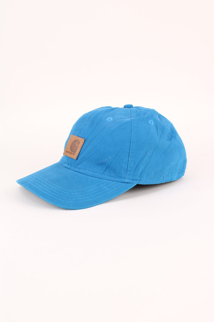 Carhartt Cap in a blue colourway with the logo embroidered on the front, and has adjustable velcro strap at the back.
