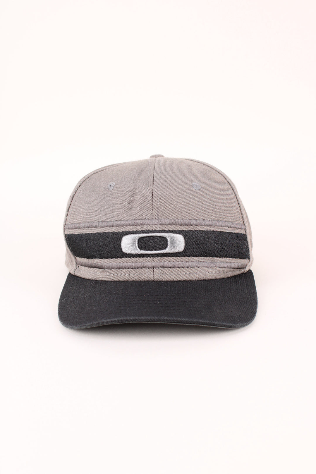 Oakley Snapback in a grey and black colourway with the logo embroidered on the front, and has adjustable velcro snapback.