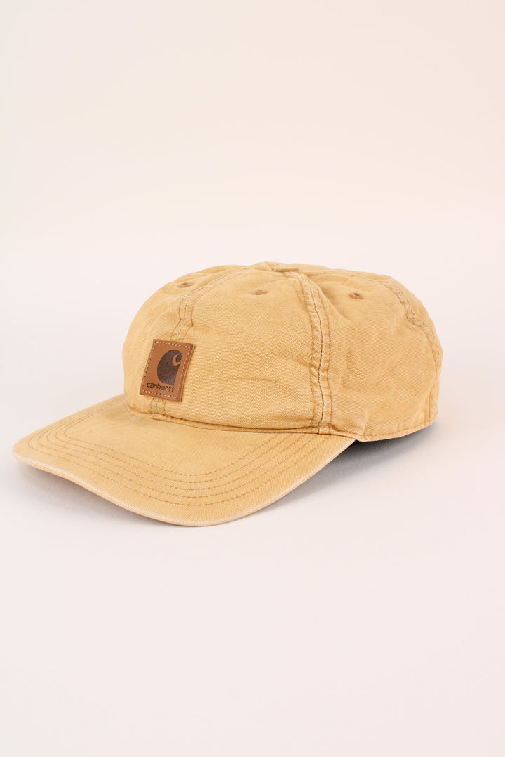 Carhartt Cap in a tan colourway with the logo embroidered on the front, and has adjustable velcro strap at the back.