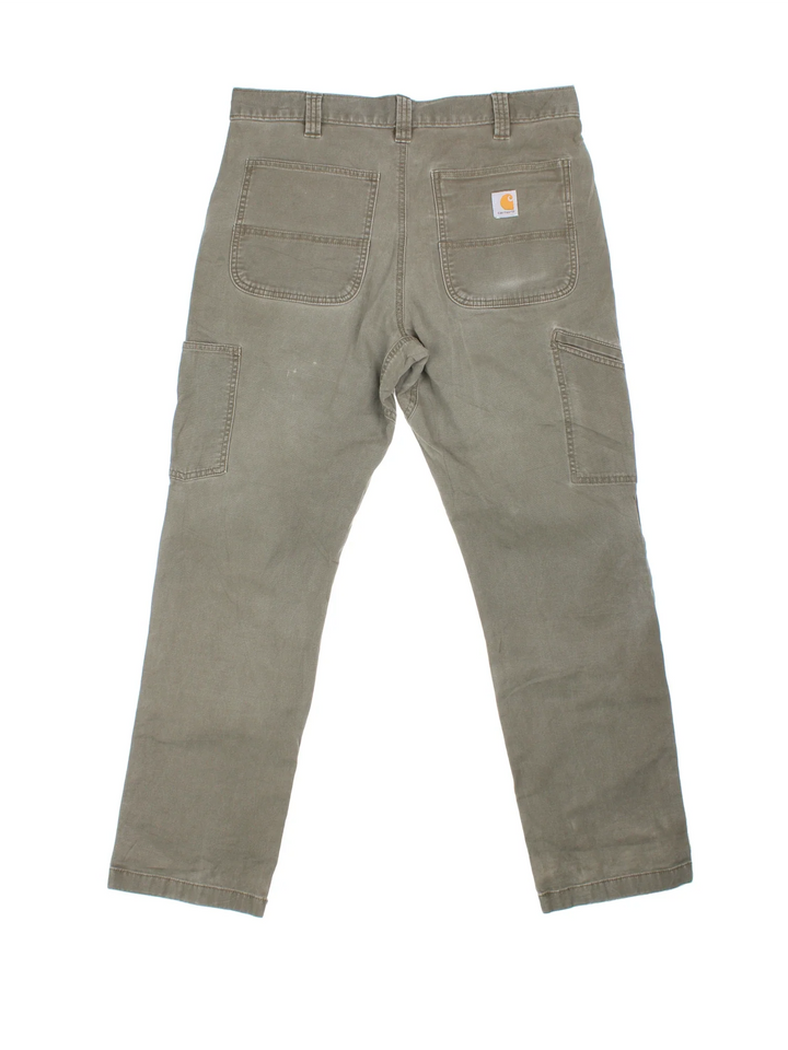 Carhartt Double Knee Trousers in a green colourway with multiple pockets and the logo embroidered on the back.