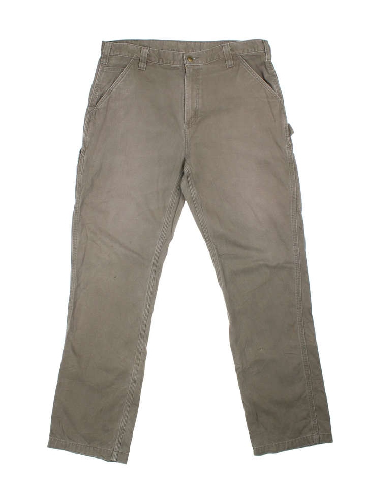 Carhartt Carpenter Trousers in a green colourway with multiple pockets and the logo embroidered on the back.