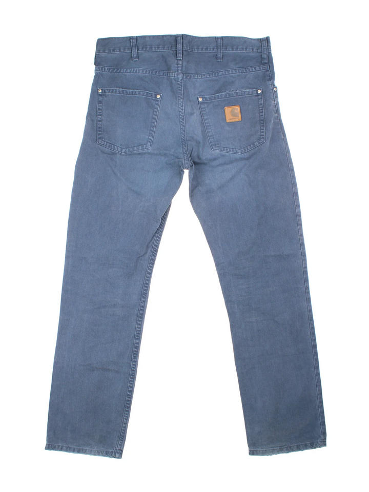 Carhartt Trousers in a blue colourway with multiple pockets and the logo embroidered on the back.