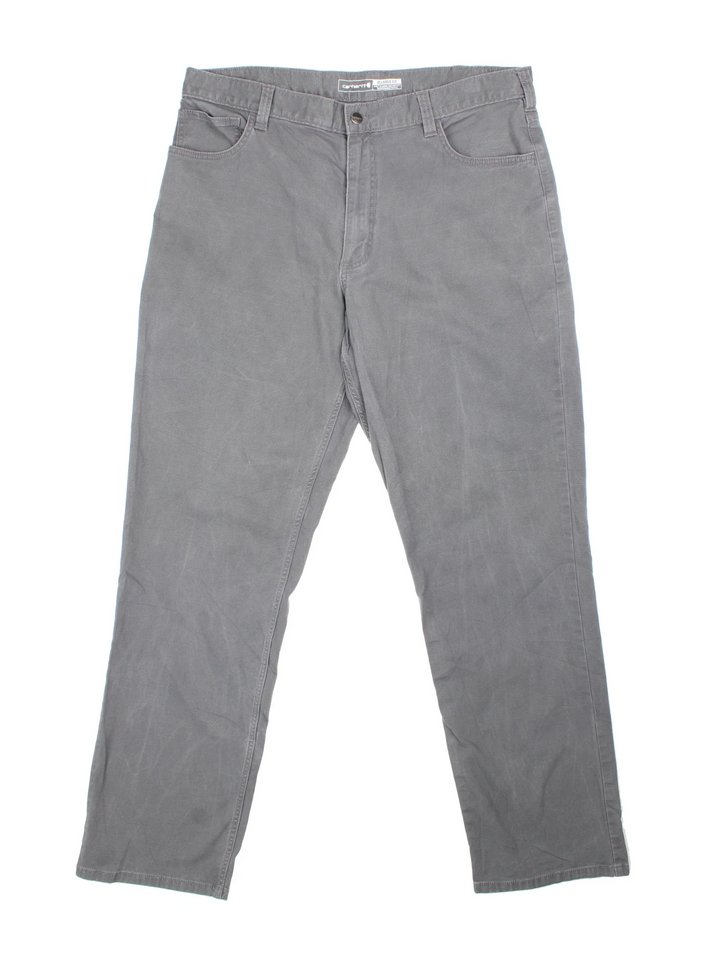 Carhartt Trousers in a grey colourway with multiple pockets and the logo embroidered on the back.