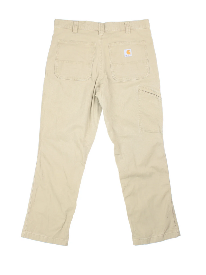 Carhartt Trousers in a tan colourway with multiple pockets and the logo embroidered on the back.