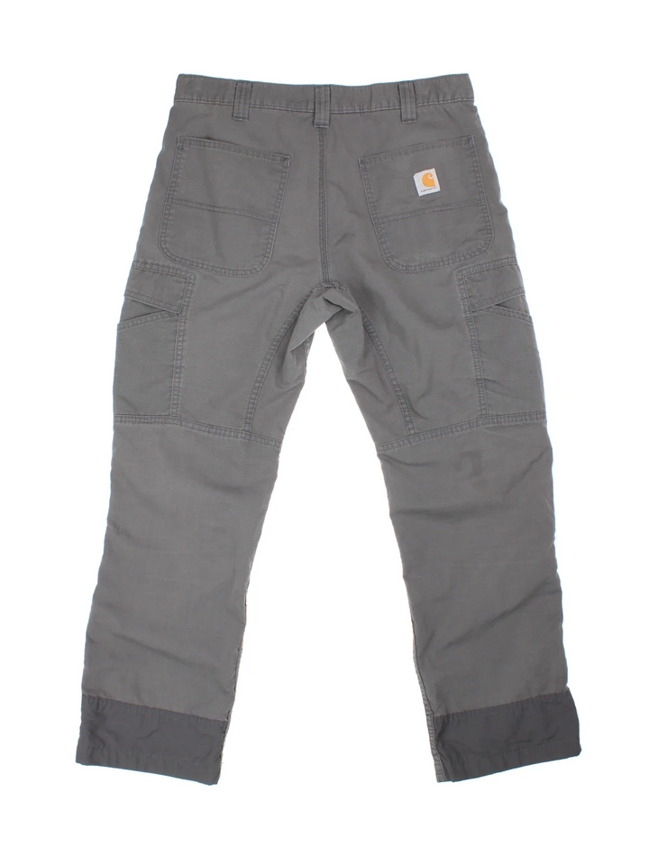 Carhartt Cargo Trousers in a grey colourway with multiple pockets and the logo embroidered on the back.
