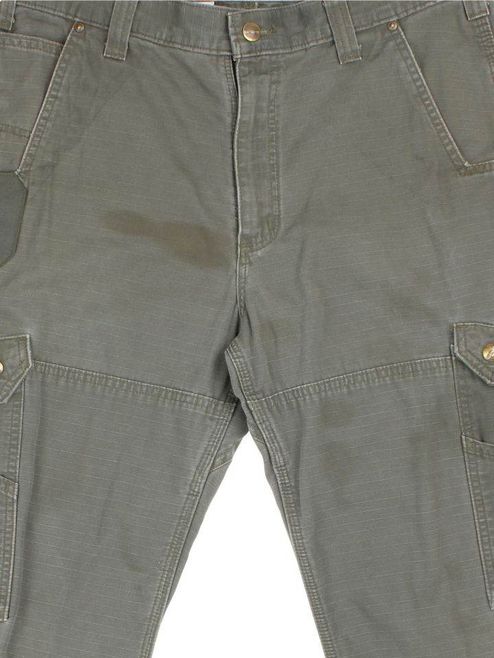 Carhartt Cargo Trousers in a green colourway with multiple pockets and the logo embroidered on the back.