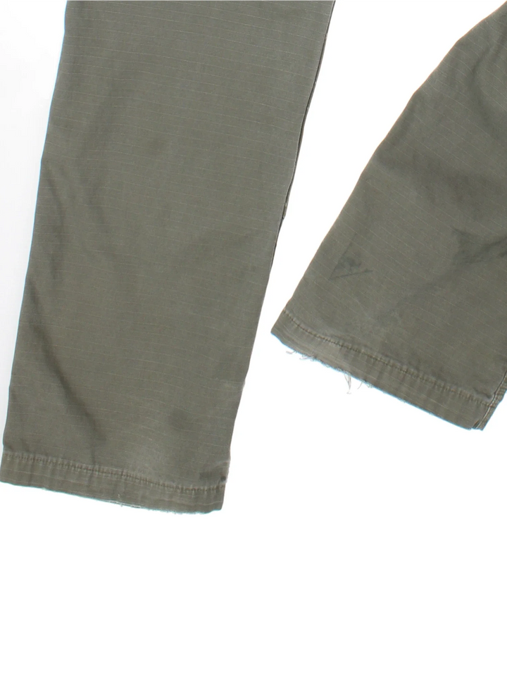Carhartt Cargo Trousers in a green colourway with multiple pockets and the logo embroidered on the back.