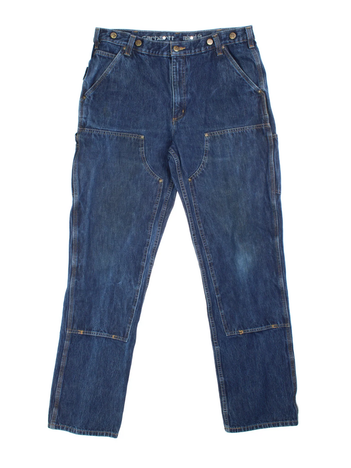 Carhartt Double Knee Jeans in a blue colourway with multiple pockets and the logo embroidered on the back.