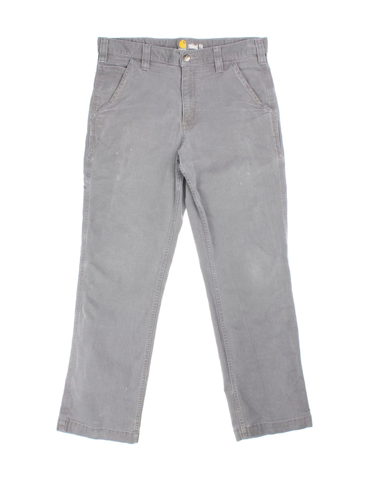 Carhartt Jeans in a grey colourway with multiple pockets and the logo embroidered on the back.
