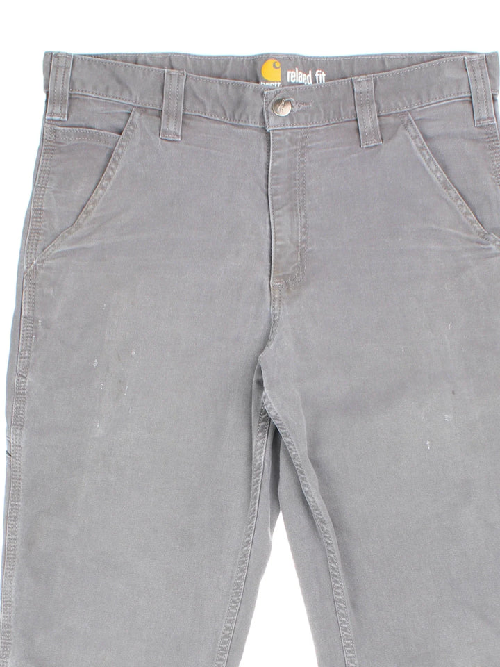 Carhartt Jeans in a grey colourway with multiple pockets and the logo embroidered on the back.
