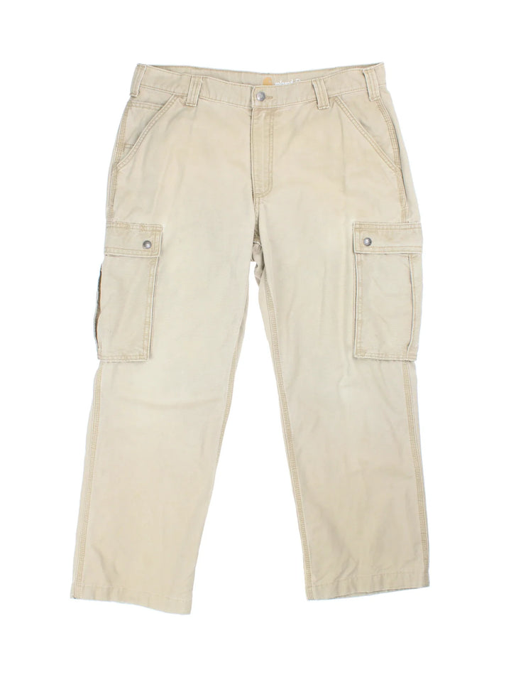 Carhartt Cargo Trousers in a tan colourway with multiple pockets and the logo embroidered on the back.