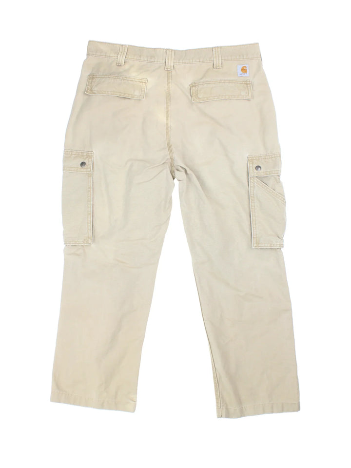 Carhartt Cargo Trousers in a tan colourway with multiple pockets and the logo embroidered on the back.