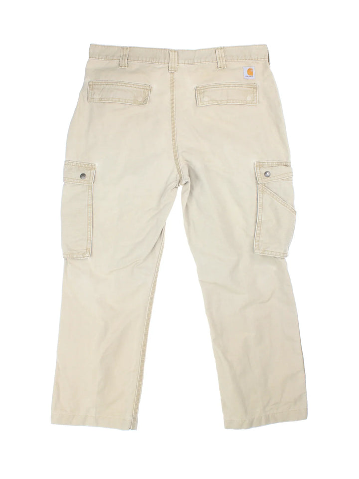 Carhartt Cargo Trousers in a tan colourway with multiple pockets and the logo embroidered on the back.