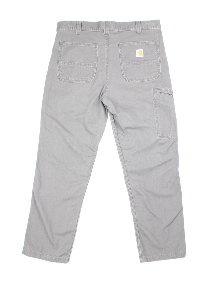 Carhartt Carpenter Trousers in a grey colourway with multiple pockets and the logo embroidered on the back.