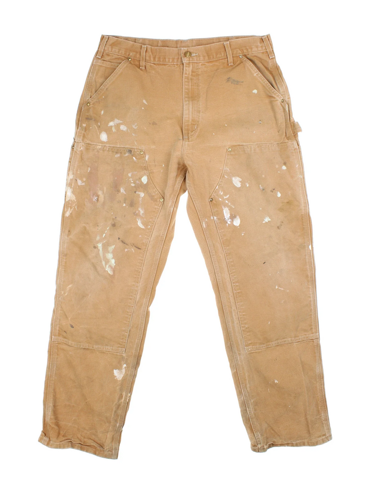 Carhartt Double Knee Jeans in a tan colourway with multiple pockets and the logo embroidered on the back.
